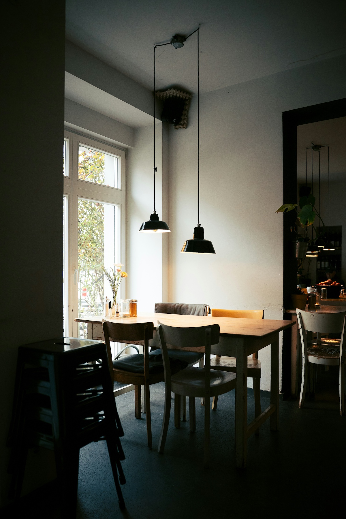 Cozy coffee shop interior at golden hour with warm side-lighting